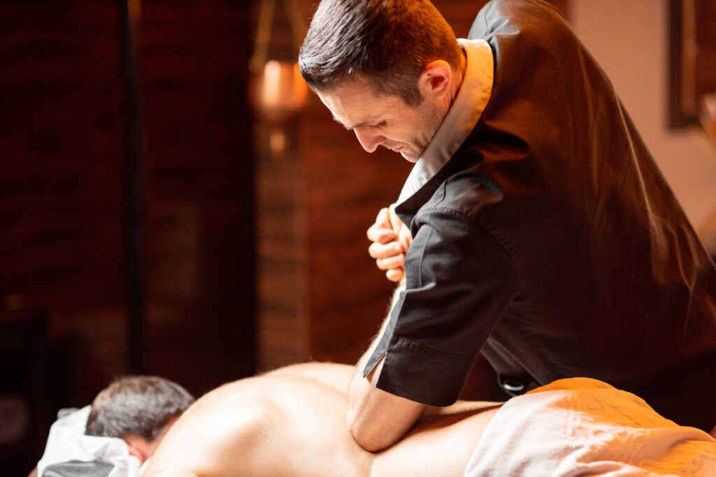Therapist performing deep tissue massage during Tulsa massage therapy at Medical Massage of Tulsa.