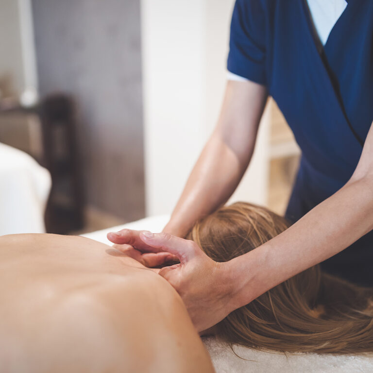 Swedish massage being performed on a client’s back at a Tulsa massage studio